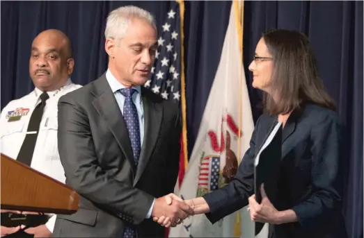  ?? COLIN BOYLE/SUN-TIMES ?? Illinois Attorney General Lisa Madigan and Mayor Rahm Emanuel shake hands Friday at a news conference to announce the consent decree draft. At left is Police Supt. Eddie Johnson.