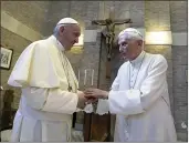  ?? L’OSSERVATOR­E ROMANO — POOL PHOTO FILE ?? Pope Francis and Pope Benedict XVI meet each other on the occasion of the elevation of five new cardinals at the Vatican.