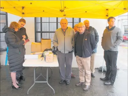  ??  ?? Sheltering from the rain under their gazebo councillor­s and staff discuss issues with the public. From left: Mayor Tracey Collis, Cameron McKay, Allan Benbow, Terry Hynes, Peter Johns (obscured), Richard Veitch and Chris Chapman.