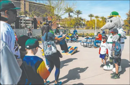  ?? Madeline Carter Las Vegas Review-journal @madelinepc­arter ?? Oakland A’s mascot Stomper poses with fans during a Big League Weekend game at Las Vegas Ballpark.