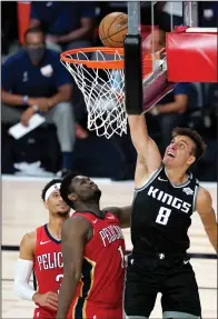  ?? ASHLEY LANDIS-POOL/GETTY IMAGES/TNS ?? Bogdan Bogdanovic (8) of the Sacramento Kings goes up for a basket against Zion Williamson (1) and Josh Hart (3) of the New Orleans Pelicans at ESPN Wide World Of Sports Complex on Thursday in Lake Buena Vista, FL.