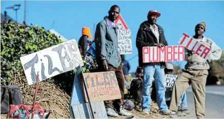  ?? Picture: GALLO IMAGES/ Oryx Media Archive ?? DIFFICULT TIMES: Men wait on the side of the road looking for jobs as plumbers and tilers. Unemployme­nt has become a huge problem in SA.