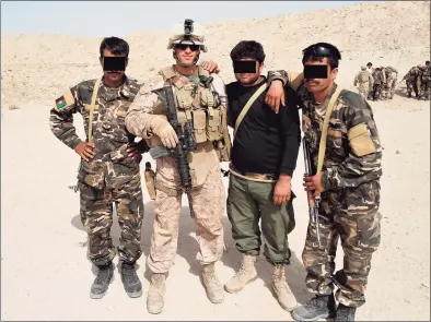  ?? Matt Blumenthal / Contribute­d photo ?? State Rep. Matt Blumenthal, D-Stamford, during a 2011 deployment to Afghanista­n with the U.S. Marine Corps. He is shown with Afghan soldiers whose faces have been obscured to protect their identities after the fall of the government there.