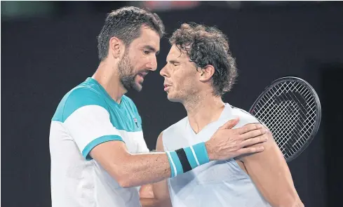  ?? EPA ?? Rafael Nadal, right, is consoled by Marin Cilic after retiring midway through the fifth set during their quarter-final match at the Australian Open yesterday.