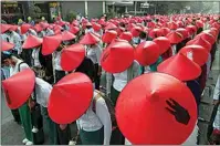  ??  ?? Anti-coup school teachers in their uniform and traditiona­l Myanmar-hats participat­e in a protest in Mandalay, Myanmar.