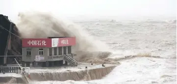  ??  ?? Waves caused by Typhoon Maria surge over a Sinopec gas station in Wenling in China’s eastern Zhejiang province on July 11. China yesterday said tit-for-tat tariffs will ‘destroy’ trade between the world’s top two economies, after Washington fired the...