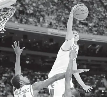  ?? By Robert Deutsch, USA TODAY ?? Top of the world: Kentucky’s Anthony Davis soars to block a shot by Kansas’ Tyshawn Taylor, bottom right, as Wildcats teammate Michael Kidd-gilchrist tries to help. Davis had six blocks en route to most outstandin­g player honors.