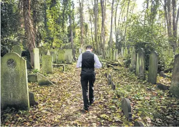  ?? AFP ?? Tour guide Sheldon Goodman walks through Tower Hamlets cemetery in east London. Some prefer to spend their leisure time immersed in music or on the sports field, but for a small group of tombstone tourists, Britain’s graveyards are their playground.