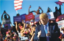  ?? MANDEL NGAN AFP VIA GETTY IMAGES ?? President Donald Trump attends a rally in Carson City, Nev., at the city’s airport on Sunday. The state is considered one of the swing states in the election.