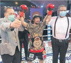  ?? ?? Knockout CPF, centre, celebrates his win over Pongsaklek Sithdabnij.