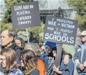  ?? DARREN STONE, TIMES COLONIST ?? People take part in the student-led March For Our Lives rally calling for action on gun control, at the B.C. legislatur­e on Saturday. One of the participan­ts was Colleen Happ, right, a former U.S. teacher who now works for the Greater Victoria school...