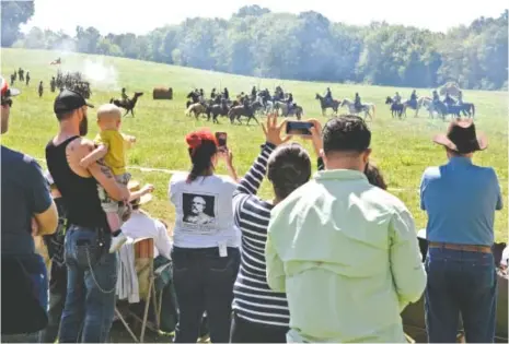  ?? STAFF FILE PHOTO ?? Spectators take photograph­s during a re-enactment of the Battle of Tunnel Hill at the Tunnel Hill Heritage Center.