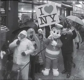  ??  ?? Jollibee and JFC North America president Jose Miñana (right) mingle with the crowd who queued up for as long as 20 hours and braved the heavy rains as well as cold weather to witness the opening of its first store in Manhattan, New York.