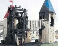  ?? BYRON JOHNSON METROLAND ?? A Mississaug­a Fire Department investigat­or looks over the charred remnants of a playhouse at Paul Coffey Park.