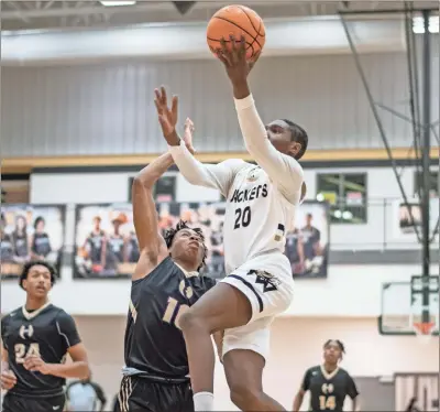  ?? Tim Godbee ?? Calhoun’s Jalen Harris drives in for the two point layup early in the first quarter against the Hiram Hornets Friday evening at The Hive. The Hornets proved to be a tough region 5A opponent for the Hometown Jackets as they defeated Calhoun 62-48.