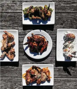  ?? Lisa Krantz / Staff photograph­er ?? Honey Sriracha Wings are surrounded by Smoked Pesto Wings (from top, clockwise), Greek Tzatziki Wings, Thai Peanut Wings and Parmesan Garlic Wings.