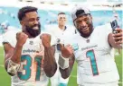  ?? JASEN VINLOVE/USA TODAY SPORTS ?? Dolphins QB Tua Tagovailoa (1) and running back Raheem Mostert (31) celebrate after beating the Jets on Sunday.