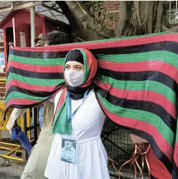  ?? /Reuters ?? Call from the heart: An Afghan woman wears a scarf with the colours of the national flag of Afghanista­n during a protest outside the UN High Commission­er for Refugees office in New Delhi on Monday to urge the internatio­nal community to help refugees from the country.