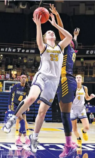  ?? STAFF PHOTO BY ROBIN RUDD ?? UTC’s Abbey Cornelius scores two of her 11 points during Friday night’s home game against UNC Greensboro. Cornelius also had 11 rebounds to help the Mocs open the SoCon series against the Spartans with a 57-41 win. The teams meet again at 1 p.m. Sunday, also at McKenzie Arena.