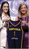  ?? AP photo ?? Iowa’s Caitlin Clark, left, poses for a photo with WNBA commission­er Cathy Engelbert, right, after being selected first overall by the Indiana Fever during the first round of the WNBA basketball draft on Monday in New York.