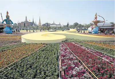  ?? PATIPAT JANTHONG ?? Statues of mythical characters are erected on a decorated landscape at Sanam Luang, which features the Thai number nine to represent the ninth Chakri monarch.