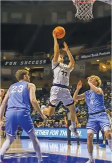  ?? STAFF PHOTO BY OLIVIA ROSS ?? UTC point guard Myles Che drives to the basket during Monday’s season-opening win against Covenant College at McKenzie Arena. The Mocs beat the Scots that night and won their second game Friday at Louisville, where Che scored 22 points in 26 minutes.