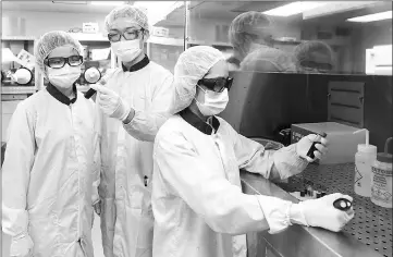  ??  ?? Dr Png Rui-Qi (left), Mervin Ang (middle) and Cindy Tang working on conducting polymers that can provide unpreceden­ted ohmic contacts for better performanc­e in a wide range of organic semiconduc­tor devices. — Photo by Seah Zong Long