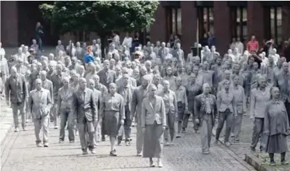  ??  ?? HAMBURG: The performanc­e ‘1000 GESTALTEN’ with hundreds of people painted like clay figures move slowly and silently through the streets of Hamburg to protest against the G-20 summit in Hamburg, northern Germany yesterday. The leaders of the group of...