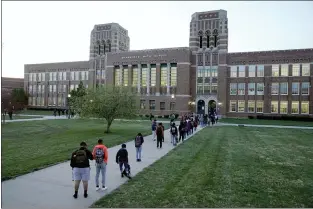  ?? CHARLIE RIEDEL — THE ASSOCIATED PRESS ?? Students wait to enter Wyandotte County High School in Kansas City, Kan., on March 31, the first day of in-person learning. As schools across the nation reopen, some students are opting to learn remotely.