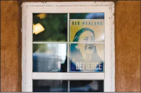  ?? ERIN SCHAFF / THE NEW YORK TIMES ?? A poster of Interior Secretary Deb Haaland hangs in a window of a home in Paraje, N.M. Many Native Americans see Haaland as hope for addressing 150 years of betrayal by a department officially entrusted with ensuring their welfare.