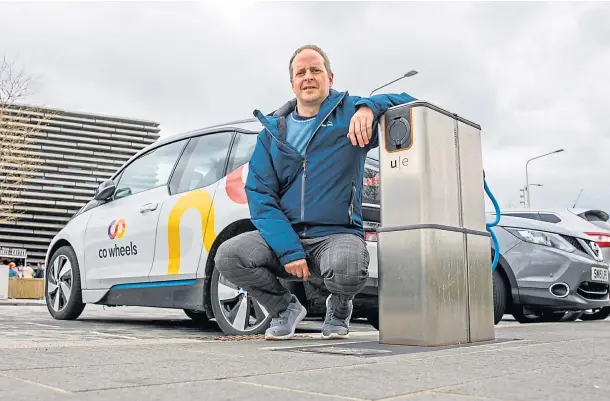  ?? ?? POWERFUL IDEA: Urban Foresight’s Gary McRae tries out one of the test pop-up chargers that is located near the V&A building in Dundee.