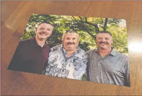  ?? MARTHA SHANAHAN/THE DAY ?? In this recent family photo, Joe Rogulski, left, and Lou Rogulski, right, pose with their biological father, David Jakobot, whom they found after taking a DNA test in April.