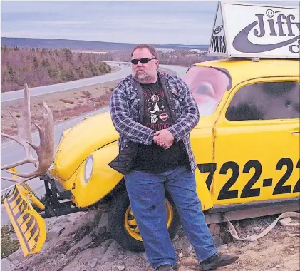  ?? TELEGRAM FILE ?? Jiffy Cabs owner/operator Tom Hollett is shown along his 1974 Volkswagen Beetle Bug on the Trans Canada Highway (TCH) just outside St. John’s in a 2009 file photo. Hollett’s family wants to hear your stories about him.