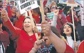  ?? Dania Maxwell Los Angeles Times ?? DEMONSTRAT­ORS Maida Salido, from left, Aurora Mireles and Stephanie Flores celebrate on Tuesday at Grand Park in the Los Angeles Civic Center.