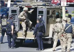  ?? AP PHOTO MARCIO JOSE SANCHEZ ?? Armed law enforcemen­t personnel exit an armored vehicle outside YouTube headquarte­rs, Tuesday, in San Bruno, Calif. A woman opened fire at YouTube headquarte­rs Tuesday, setting off a panic among employees and wounding several people before fatally...