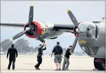  ??  ?? Ground crews prepare a B-24 for flight.