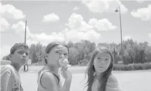  ??  ?? From left, Christophe­r Rivera, Brooklynn Prince and Valeria Cotto as young residents of a motel in The Florida Project.