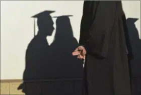  ?? BERNARD THOMAS — THE HERALD-SUN VIA AP, FILE ?? University graduates cast shadows on a wall before a commenceme­nt in Durham, N.C. In its June 2017 issue, a leading journal of political philosophy took up the Black Lives Matter movement without a single contributi­on from a black academic, triggering...