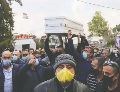  ?? ISSAM ABDALLAH / REUTERS ?? Mourners carry the coffin of 36-year-old telecoms employee and freelance photograph­er Joe Bejjany at his
funeral Tuesday in the village of Kahaleh after he was killed assassin-style by two men with a silencer.