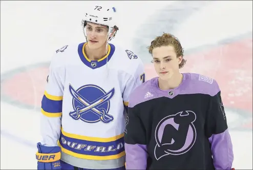  ?? Rich Grassle / Icon Sportswire via Getty Images ?? The Devils’ Tyce Thompson, right, poses for photos with his brother, Sabres winger Tage Thompson, before Tyce’s fist NHL game on Tuesday at the Prudential Center in Newark, NJ.