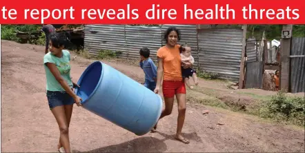  ??  ?? Challenges… Young children carry a plastic container as they head to a meeting point to collect water from a tanker in a poor neighbourh­ood on the outskirts of Tegucigalp­a.