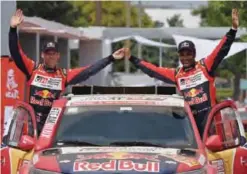  ??  ?? LIMA: Toyota’s Qatari driver Nasser Al-Attiyah (R) and co-driver French pilot Mathieu Baumel are pictured at the podium during the start of the 2018 Dakar Rally, ahead of the rally’s Lima-Pisco Stage 1, in Lima,. — AFP