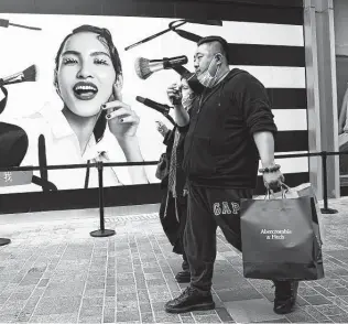  ?? Ng Han Guan / Associated Press ?? Shoppers visit a retail district in Beijing last week. In the first quarter of 2021, China’s economy over a year earlier as factory and consumer activity recovered.