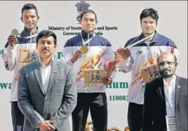  ?? HT ?? 100m winner Nisar Ahmad (centre) and other medallists with sports minister RVS Rathore (left).