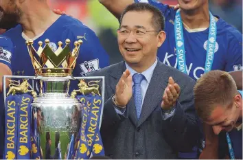  ?? AP file ?? Vichai Srivaddhan­aprabha applauds beside the trophy as Leicester City celebrate their Premier League title, after a fairy tale run, at King Power Stadium in 2016.