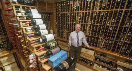  ?? BERNARD WEIL/TORONTO STAR ?? Alex Manikas, Bardi’s Steak House owner, shows off his cellar. The wine list of nearly 450 selections ranges from Old World classics to new discoverie­s.