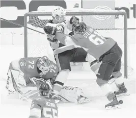  ?? ANDRE RINGUETTE/GETTY ?? Panthers’ Riley Stillman shoves Islanders’ Anders Lee during Game 3 of the Eastern Conference play-in series Wednesday at Scotiabank Arena in Toronto.