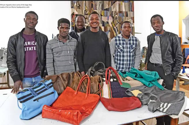  ?? (AFP) ?? African migrants show some of the bags they made at the Lai-Momo headquarte­rs