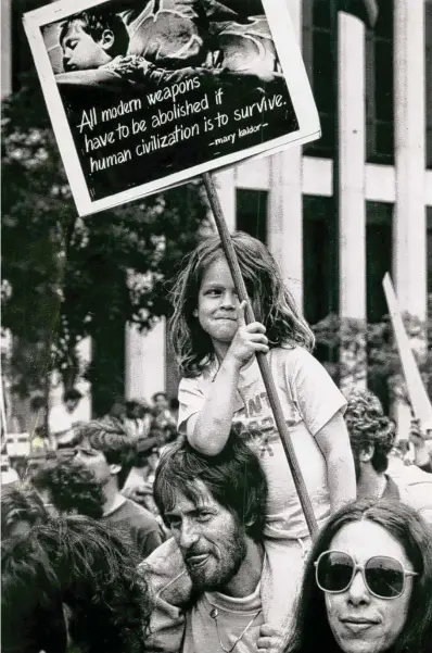  ?? Christian Science Monitor News Service ?? Concerned citizens for nuclear disarmamen­t march past the United Nations in New York on June 12, 1982, professing hope for the next generation.