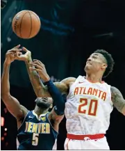  ?? John Bazemore /
The Associated Press ?? Atlanta forward John Collins (20) and Denver guard Will Barton (5) battle for a rebound in the first half of Friday’s game.